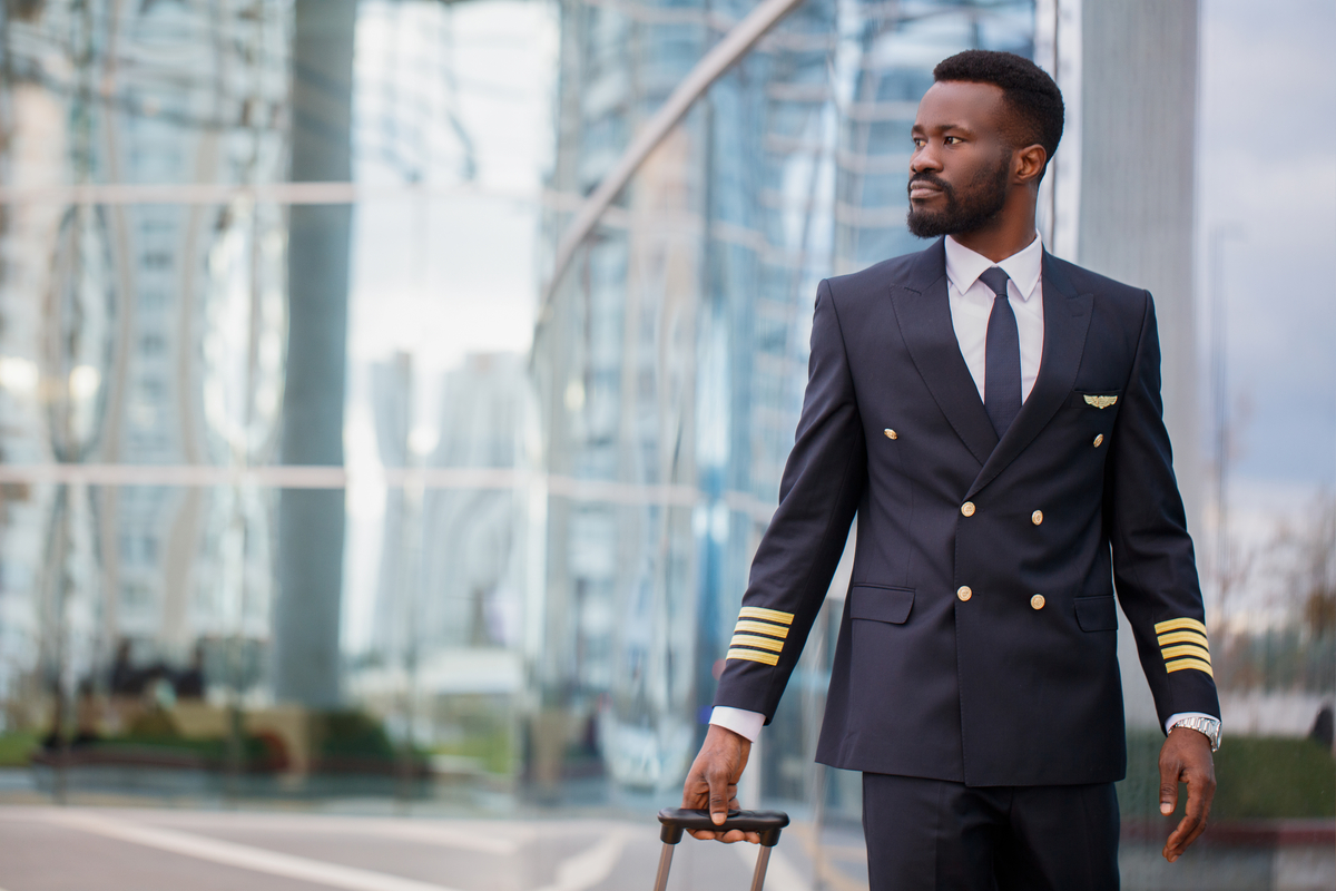 Black person pilot walking at the airport